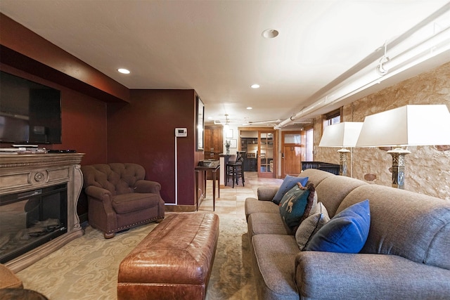 living room with a glass covered fireplace and recessed lighting