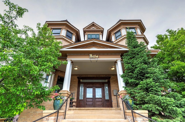 property entrance with french doors and brick siding