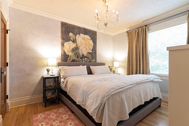 bedroom with baseboards, a notable chandelier, wood finished floors, and crown molding