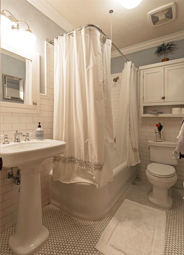 full bath featuring visible vents, crown molding, tile patterned floors, toilet, and tile walls