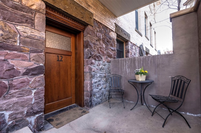 entrance to property featuring stone siding