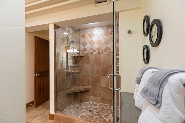 bathroom with an enclosed shower and tile patterned flooring