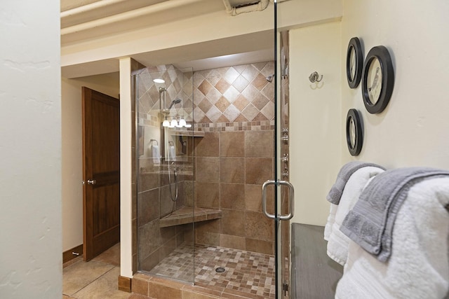 full bath with a shower stall and tile patterned floors