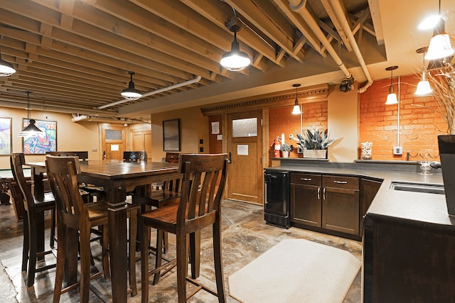 tiled dining room featuring brick wall, sink, and wine cooler