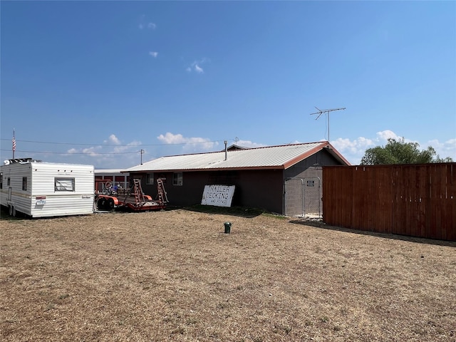 view of front of home featuring an outbuilding and metal roof