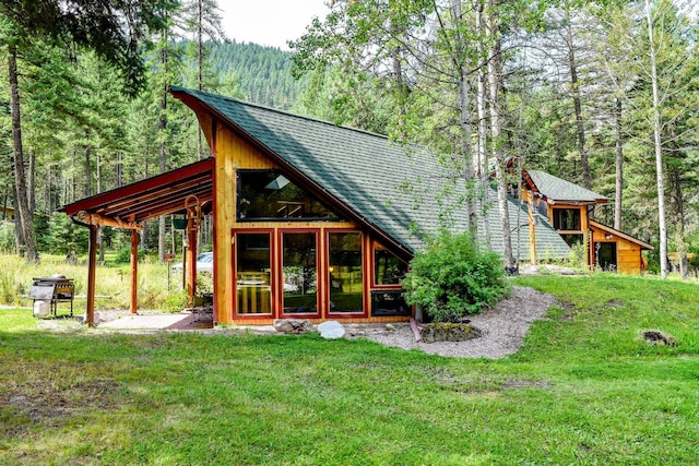 rear view of house with a yard