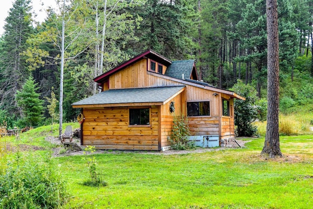 view of outbuilding with a lawn