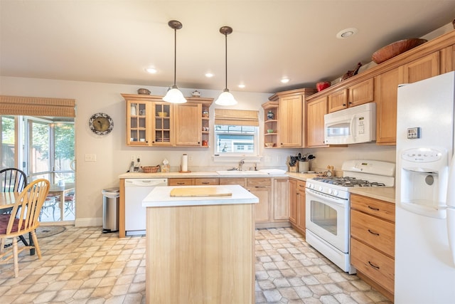 kitchen featuring white appliances, a kitchen island, open shelves, a sink, and light countertops