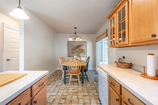 dining area featuring a chandelier and baseboards