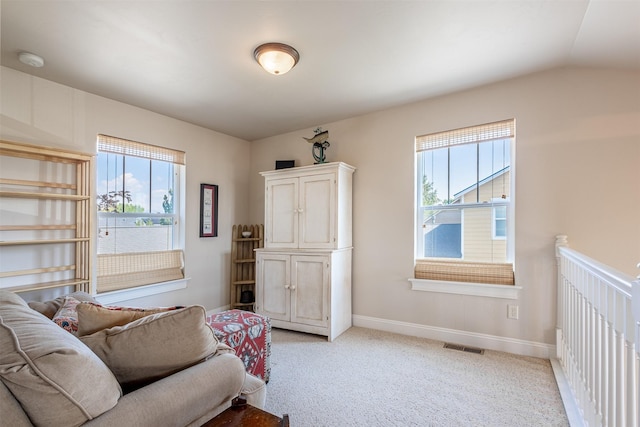 bedroom with visible vents, baseboards, light colored carpet, and vaulted ceiling