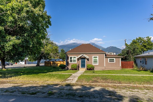 bungalow featuring a front lawn and a mountain view