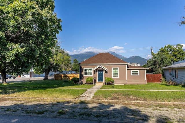 bungalow with a mountain view and a front lawn