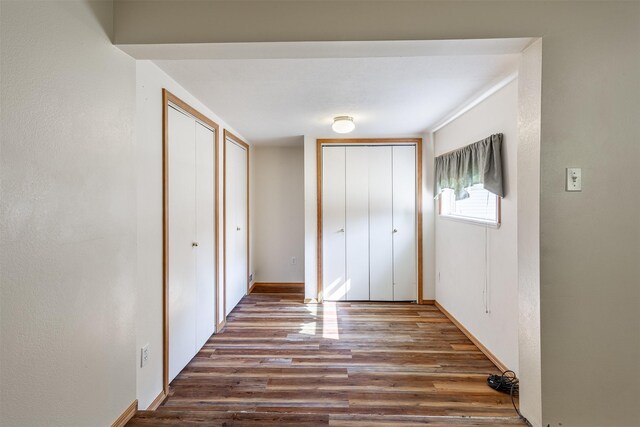 corridor featuring wood-type flooring