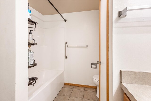 full bathroom featuring  shower combination, vanity, tile patterned flooring, and toilet