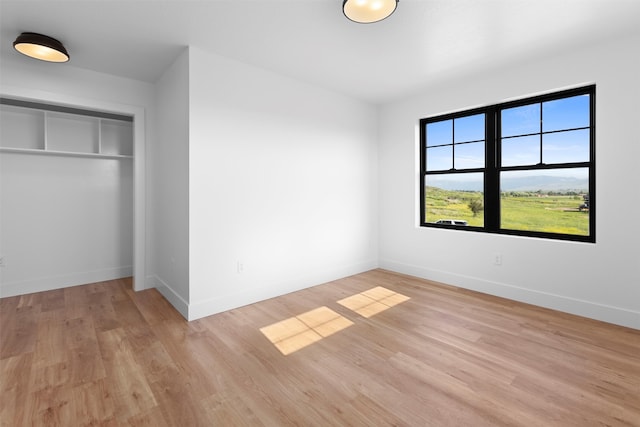 empty room with light hardwood / wood-style floors