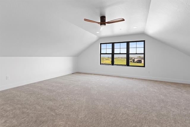 bonus room featuring ceiling fan, a textured ceiling, carpet floors, and vaulted ceiling