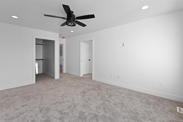 unfurnished bedroom with ceiling fan and light colored carpet