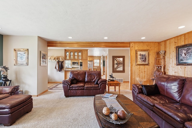 living room with wooden walls and carpet flooring