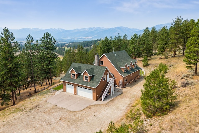 birds eye view of property with a mountain view