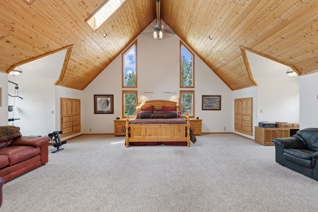 bedroom featuring wooden ceiling, high vaulted ceiling, beam ceiling, a skylight, and light colored carpet