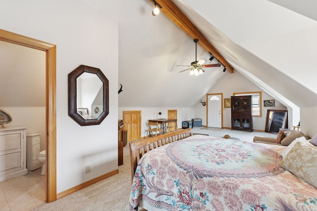 bedroom featuring light tile patterned flooring, lofted ceiling with beams, connected bathroom, and ceiling fan