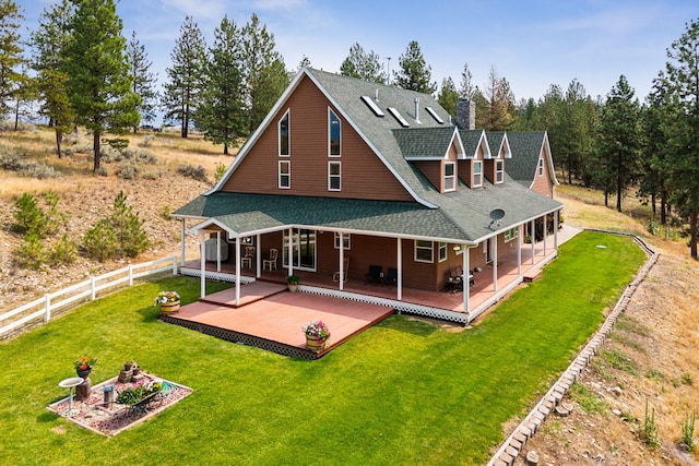 back of house with a yard and a deck