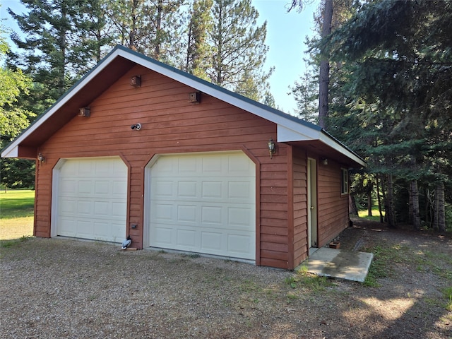 garage featuring wood walls