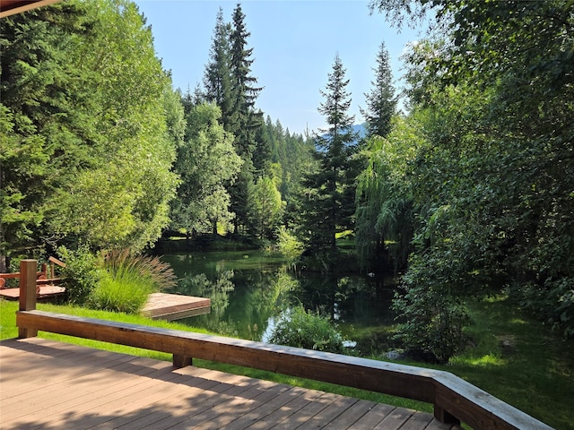 wooden terrace featuring a water view