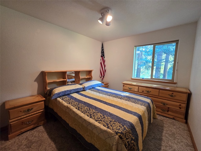 carpeted bedroom featuring a textured ceiling