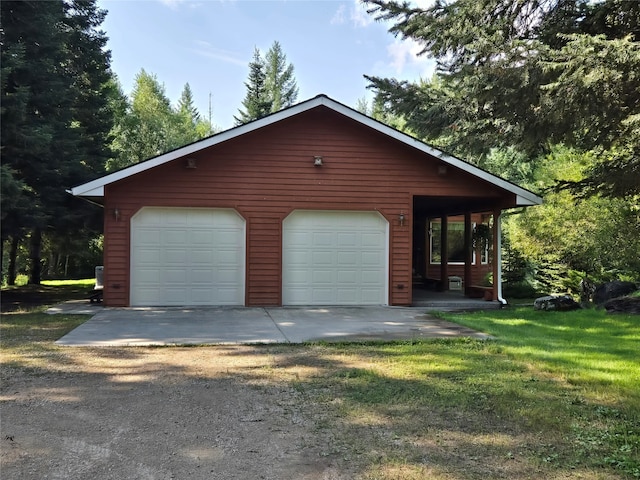 view of front facade with a garage, a porch, and a front yard