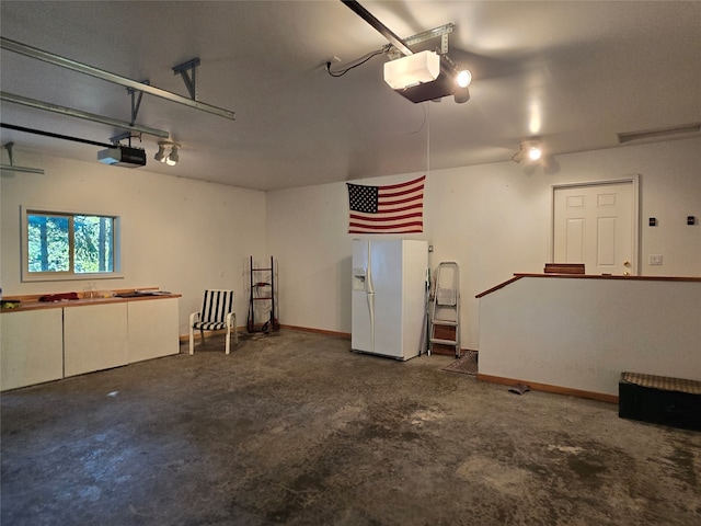 garage with white refrigerator with ice dispenser and a garage door opener