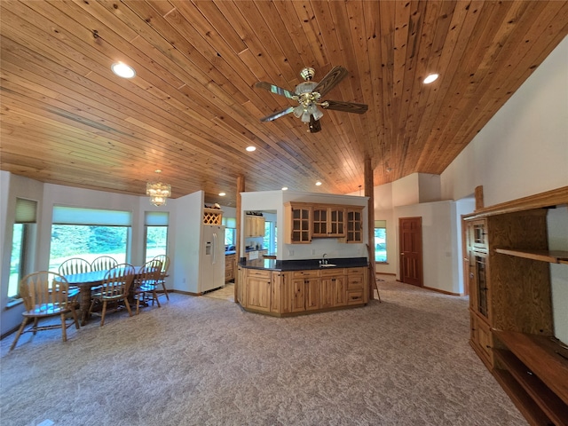 living room with wood ceiling, light colored carpet, ceiling fan, and sink