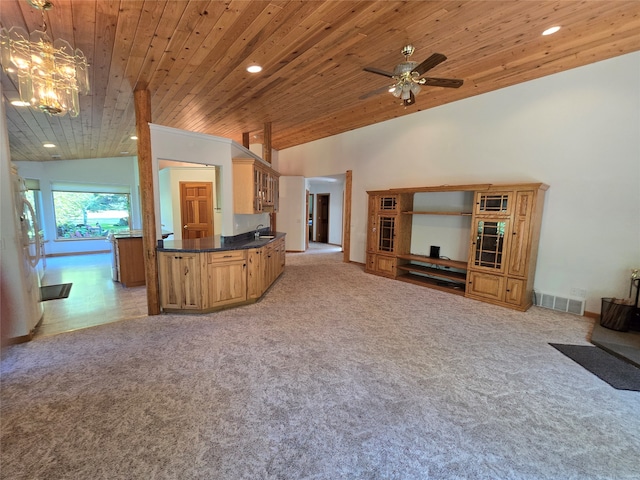 unfurnished living room with ceiling fan with notable chandelier, wood ceiling, light carpet, sink, and high vaulted ceiling