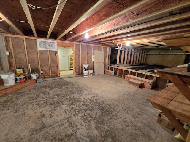 basement featuring white refrigerator