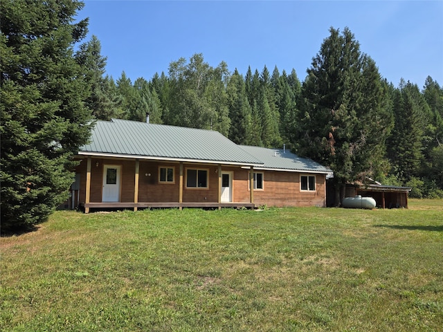 view of front of home with an outbuilding and a front yard