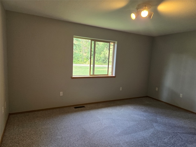 unfurnished room featuring carpet