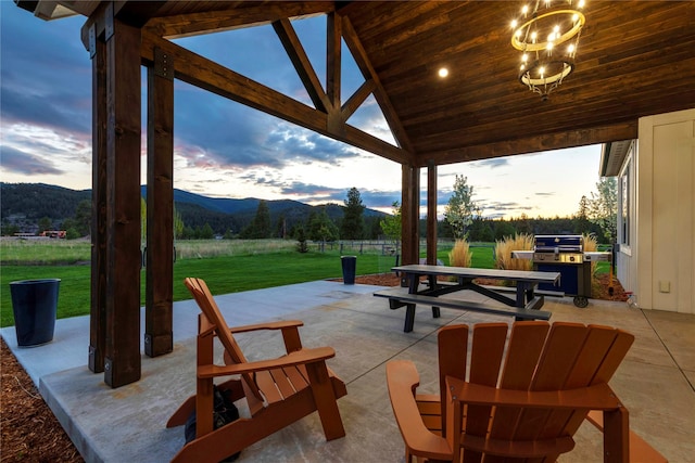 view of patio featuring a gazebo, area for grilling, and a mountain view