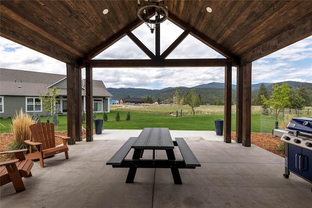 view of patio with a gazebo and a mountain view