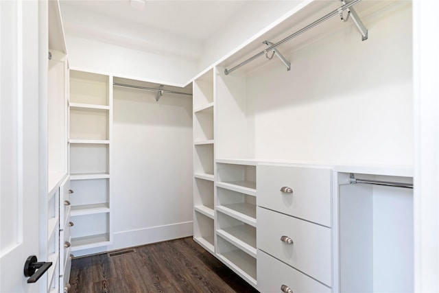 spacious closet featuring visible vents and dark wood-style floors