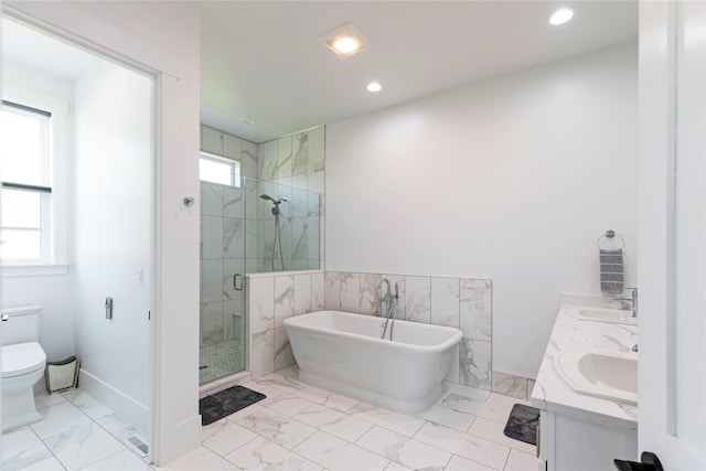 bathroom with a marble finish shower, a freestanding bath, toilet, marble finish floor, and a sink