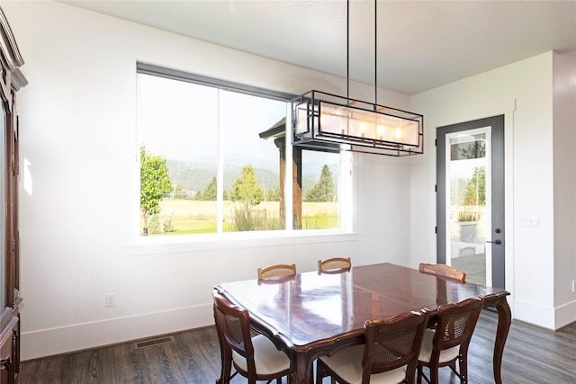 dining space with visible vents, a mountain view, baseboards, and dark wood-style flooring