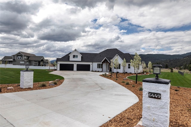 modern inspired farmhouse featuring a garage, concrete driveway, and a front yard