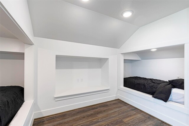 interior space featuring dark wood-style floors, recessed lighting, baseboards, and vaulted ceiling