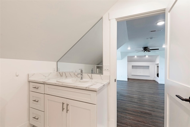 bathroom featuring visible vents, a ceiling fan, wood finished floors, lofted ceiling, and vanity