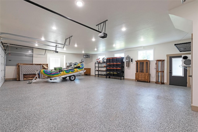 garage featuring a garage door opener and baseboards