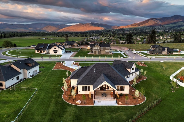 aerial view at dusk with a residential view and a mountain view