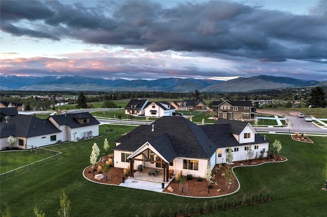 aerial view at dusk with a mountain view and a residential view