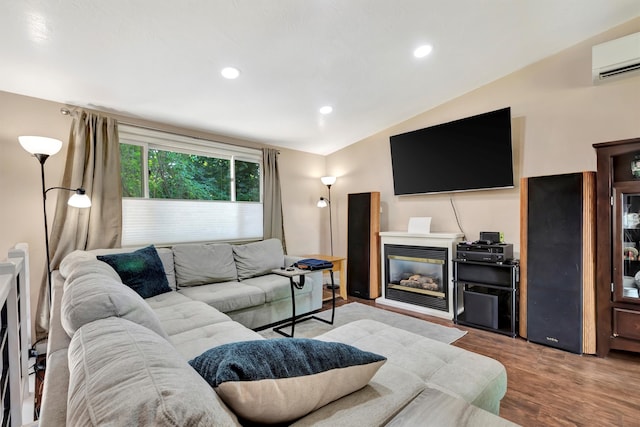 living room with lofted ceiling, light hardwood / wood-style flooring, and a wall mounted AC