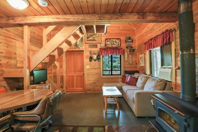 living room with a wood stove, wooden walls, wood ceiling, and vaulted ceiling with beams