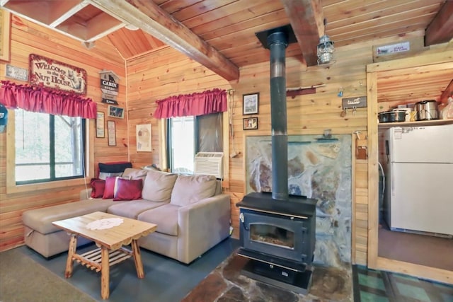 living room featuring a wood stove, lofted ceiling with beams, wooden walls, and wooden ceiling